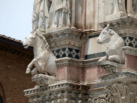 Architectural details of Duomo facade - Siena,Tuscany,Italy. The Duomo of Siena, which was built in the 12th and 13th centuries, is one of the prettiest churches in Gothic style in Italy
