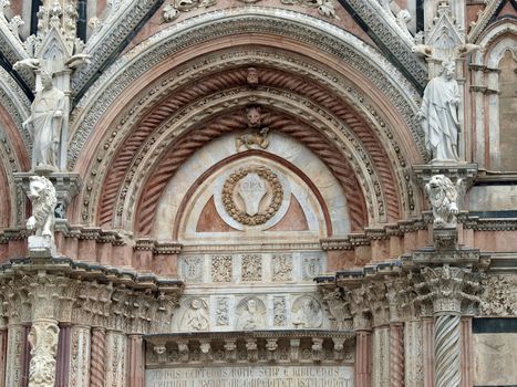 Siena - marble Duomo portal. The Duomo of Siena, which was built in the 12th and 13th centuries, is one of the prettiest churches in Gothic style in Italy