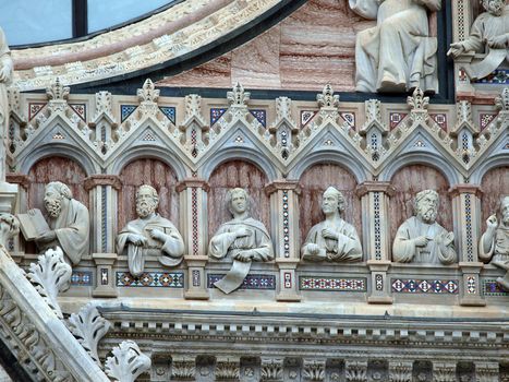 Architectural details of Duomo facade - Siena,Tuscany,Italy. The Duomo of Siena, which was built in the 12th and 13th centuries, is one of the prettiest churches in Gothic style in Italy