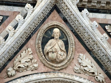 Architectural details of Duomo facade - Siena,Tuscany,Italy. The Duomo of Siena, which was built in the 12th and 13th centuries, is one of the prettiest churches in Gothic style in Italy