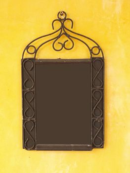 Blank menu board on yellow wall, put any text here