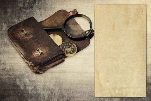 Vintage background with old paper, wallet and compass