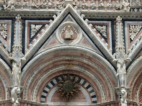 Siena - marble Duomo portal. The Duomo of Siena, which was built in the 12th and 13th centuries, is one of the prettiest churches in Gothic style in Italy