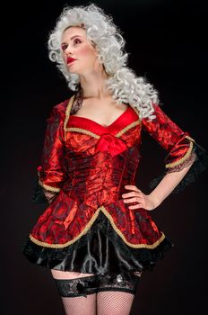 Young woman in baroque custome against dark background