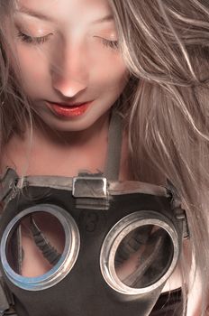 Woman in gasmask against dark background