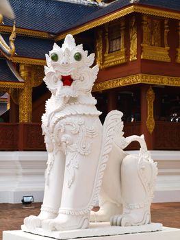 A white stucco lion in Wat Baan Den in Chiang Mai, Thailand, traditional lion, guardian, symbol of power and descendant.