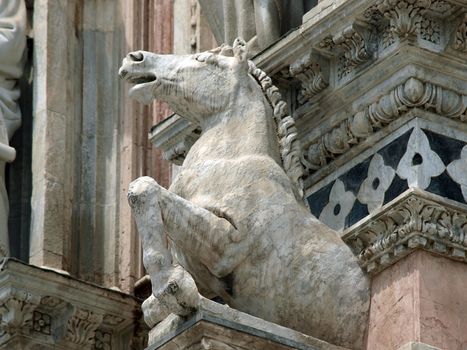 Architectural details of Duomo facade - Siena,Tuscany,Italy. The Duomo of Siena, which was built in the 12th and 13th centuries, is one of the prettiest churches in Gothic style in Italy