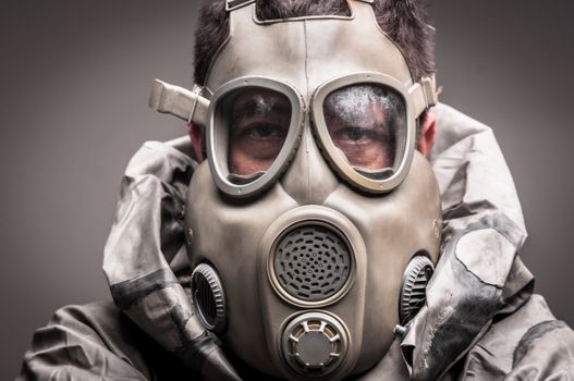 Man in protective suit against dark background