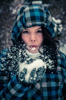 Attractive young woman with snow in her hand