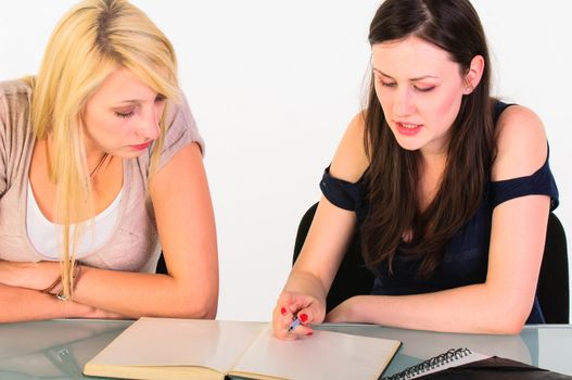 Two beautiful student girls getting ready for school isolated