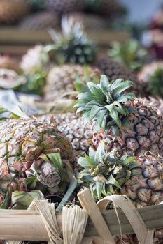 Pineapples in Basket at Fruits and Vegetables Market in Southeast Asia Closeup