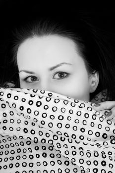 Young woman in the bed in bright light