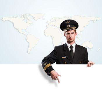 pilot in the form of holding an empty billboard on the background of map of the world, place for text