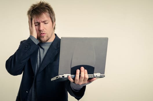 Young man in business suit against white background