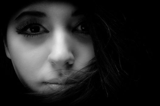 Artistic closeup photo of a young woman in studio