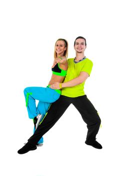 Acrobatic dancing with two young trainers on white background