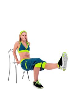 Young fitness instructor sitting on chair
