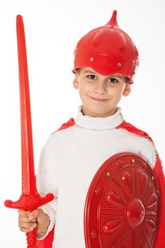 Young Boy Dressed Like a knight holding a sword and shield isolated on white