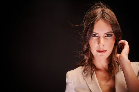 Beautiful young woman against dark background