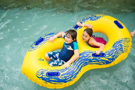 Boy and girl in a tube in a pool at Jay Peak's waterpark