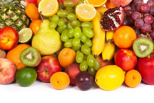 Huge group of fresh fruits isolated on a white background. Shot in a studio