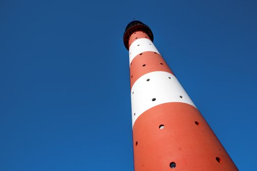 Horizontal closeup of the lighthouse Westerhever against a blue sky in Germany