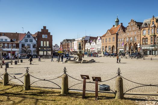 Market place in Husum with Tine fountain on a sunny day in spring