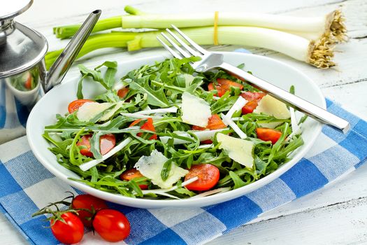 salad with arugula, cherry tomatoes, parmesan and shallot