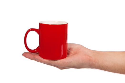 Male hand is holding a red cup isolated on a white background