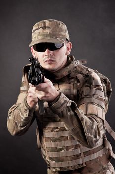 Modern soldier with rifle isolated on a black background