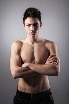 Portrait of young bodybuilder man on a black background