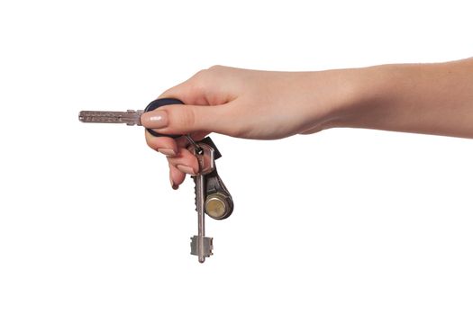 Female hand holding a key to the house, image is taken over a white background.