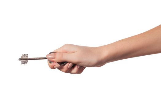 Female hand holding a key to the house, image is taken over a white background.