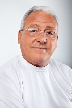 Portrait of smiling senior man wearing glasses