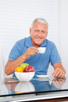 Portrait of smiling senior man having cup of tea