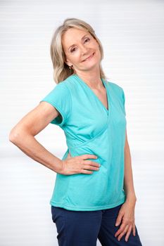 Portrait of smiling mature woman posing over white background