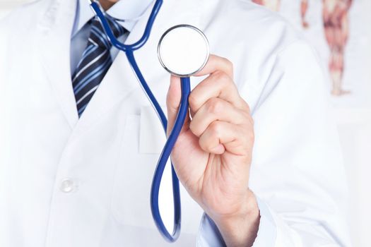 Close-up of male doctor holding stethoscope .