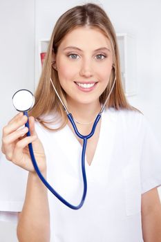 Female doctor with a stethoscope listening.