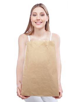 Young happy woman holding shopping paper bag.