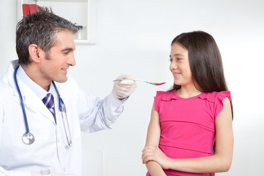 Girl child take medicine from doctor.