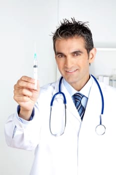 Happy doctor holding syringe in hand.