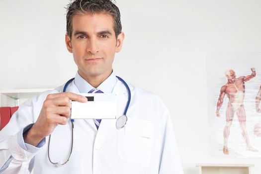 Portrait of male doctor holding a medicine packet.