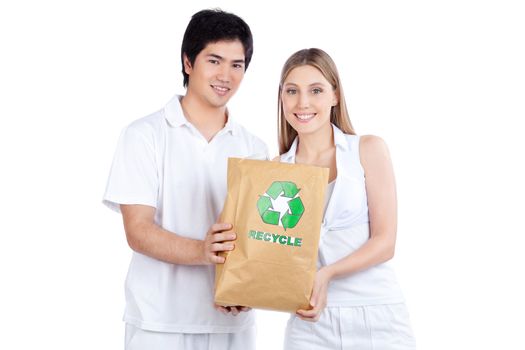 Portrait of young happy couple holding paper bag.