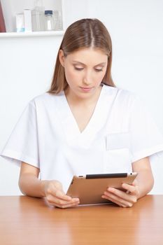 Medical professional using digital tablet.