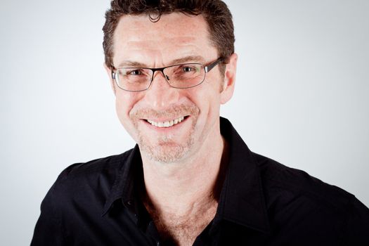 attractive adult man with glasses and black shirt portrait 