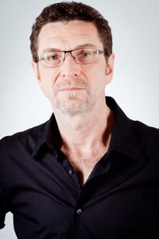 attractive adult man with glasses and black shirt portrait 