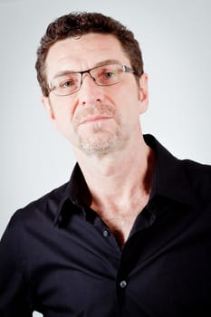 attractive adult man with glasses and black shirt portrait 
