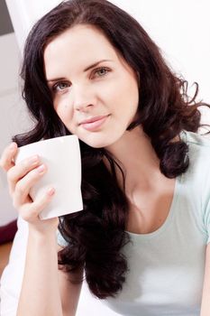 smiling brunette woman drinking black coffee in the morning