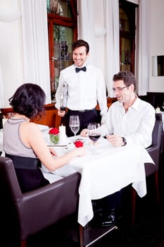 waiter serve fresh espresso for happy couple in restaurant