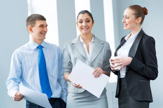 group of business people discussing documents in the office